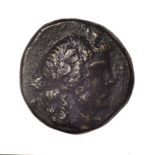 Bronze coin, Pantikapaion; obverse: head of young Dionysus in ivy wreath facing right; reverse: bow