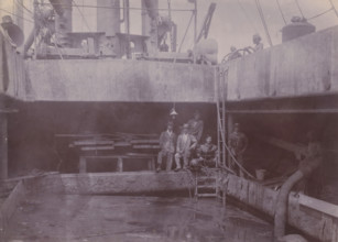 Japanese divers on hold II, photograph, A Japanese diving team poses at the edge of the hold of a