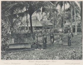 Inhabitants of Batak village 'Pintoe-Bessi' on Sumatra, with a grave in the foreground, Batak -