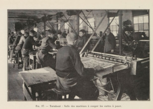 Men cut out printed playing cards in a printing house in Turnhout, page, photomechanical print,