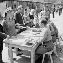A Polish family registering at No.17 Displaced Persons Assembly Centre in Hamburg Zoological Gardens, 18 May 1945. The D