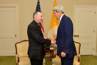 U.S. Secretary of State John Kerry greets Vatican Secretary of State Archbishop Pietro Parolin before their bilateral me