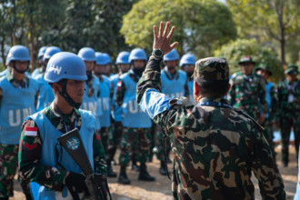 RECORD DATE NOT STATED  A Nepali solider, serving as a field training exercise instructor, advises Indonesian National A