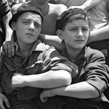 Israel / Palestine: Jewish children rescued from the Nazi concentration camp at Auschwitz show their tattoos on board th