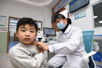 Vaccination Services in Guiyang GUIYANG, CHINA - MARCH 14, 2024 - A medical worker inoculated a child with inactivated h