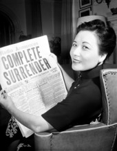 China / USA: Soong May-ling or Mei-ling, also known as Madame Chiang Kai-shek (1898-2003), reads the news of Japan s Com