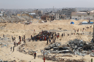 People scramble for humanitarian aid dropped by a plane in the southern Gaza Strip city of Khan Younis, People scramble