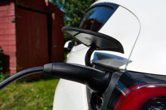 Bavaria, Germany - June 24, 2025: Detailed view of a Tesla Model Y during the charging process. A charging cable is conn