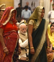 NEW DELHI, INDIA MARCH 14: Prime Minister Narendra Modi looks on as the mother and wife of late Rajendra Kumar Nain, Ce