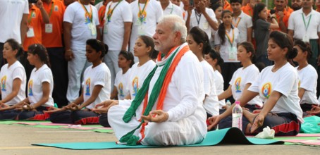 NEW DELHI, INDIA - JUNE 21: Prime Minister Narendra Modi performs yoga along with others at Rajpath during mass yoga se