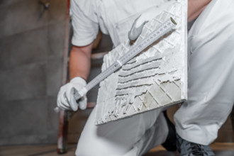 Bavaria, Germany - August 25, 2025: The tile is measured precisely with a folding rule to ensure a perfect fit. A precis