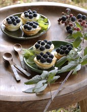 Typical French buffet: tartlets with blackberries and violet cream