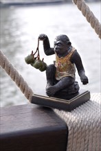 Yachting menu: statuette of a monkey layed on a rope
