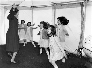 Prime Minister Margaret Thatcher seen here leading a group of children in a session of physical