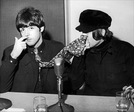 The Beatles Paul McCartney and John Lennon pictured at a backstage news press conference at the