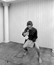 Beatles at pool in a private home in Los Angeles. Ringo Starr playing cowboy at Beatles Bel Air