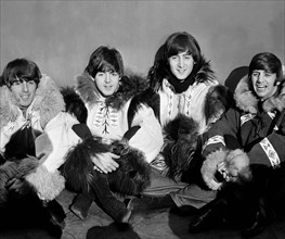 The Beatles pose for a group shot wearing eskimo outfits