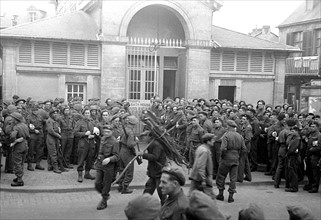 British troops outside the bath house in a Normandy town in Northern France shor;tly after the