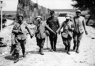 World War One -  British & French wounded soldiers walk back from the war front towards friendly