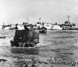 D Day Normandy. The American forces drive up on to the beach in an amphibian vehicle from landing