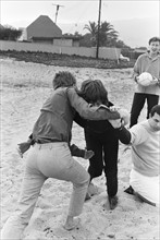 The Rolling Stones. Mick Jagger and manager Andrew Loog Oldham seen here wrestling on Malibu beach,