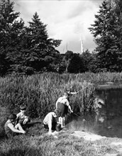 Boys fishing in the river circa 1939