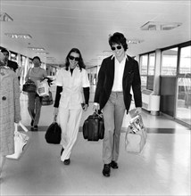 American actor Warren Beatty at Heathrow Airport with Michelle Phillips. 
May 1975