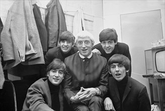 Disc Jockey Jimmy Saville pictured with Liverpool pop group The Beatles at Finsbury Park Astoria in