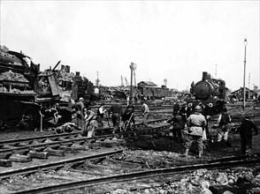 French railway workers helping American soldiers to repair track in Cherbourg 1944 WW2