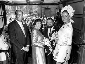 Elizabeth Taylor, Matron of Honour, and Richard Burton, Best Man, leaving Caxton Hall in London