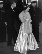Princess Elizabeth wearing an elegant long dress and fur stoll attends an the premiere of the film