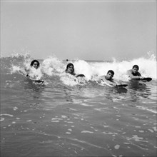 Women body boarding in the surf at Newquay June 1960