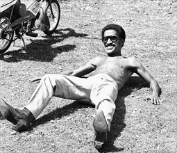 Sammy Davis Junoir seen here relaxing  whilst on location at Eastnor Castle, Ledbury during filming