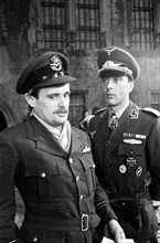 Actors David McCallum (left) and Anthony Valentine on the film set during filming of 'Colditz', the