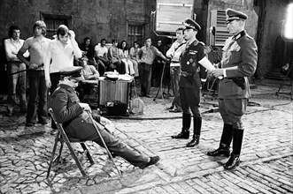 Actor David McCallum (seated) on the film set during filming of 'Colditz', the BBC TV series. He