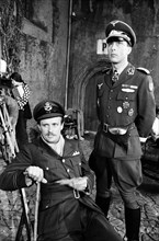 Actors David McCallum (left) and Anthony Valentine on the film set during filming of 'Colditz', the