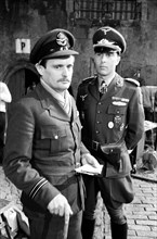 Actors David McCallum (left) and Anthony Valentine on the film set during filming of 'Colditz', the