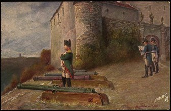 Napoleon I standing next to a town's defences, flanked by cannons.