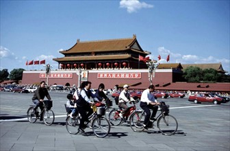 People riding bike in front of Tian'anmen Square