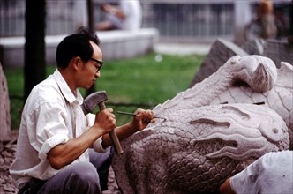 A man carving stone