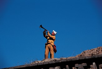 Man playing a trumpet, China