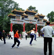 Old people doing morning exercises at the gate of the Jingshan Park?Beijing, China