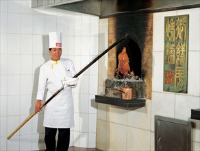 A cook makes Beijing roasted duck