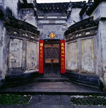 The art and the folk couplet on the front gate of a residence in Yixian County,Anhui Province,China