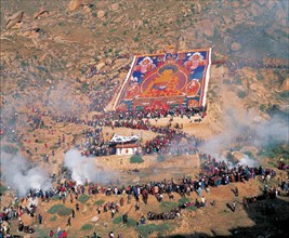 People celebrate the Shoton Festival by unfolding a large Buddha's portrait in Tibet,China