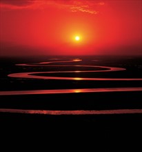 The sun sets on Swan Lake of Bayanbulak grassland, Xinjiang,China