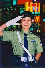 A policewoman salutes on Nanjing Road,Shanghai,China