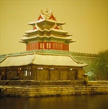 a corner tower of the Forbidden City in snow,Beijing,China