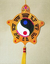 A folk art of Chinese Fragrance Bag with an image of the Eight Diagrams on its cover