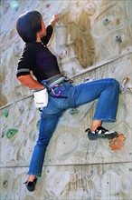 A Chinese woman climbing rock
